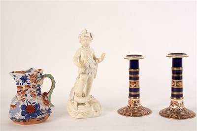 Lot 271 - A Derby biscuit figure of Cupid, 24cm high,...