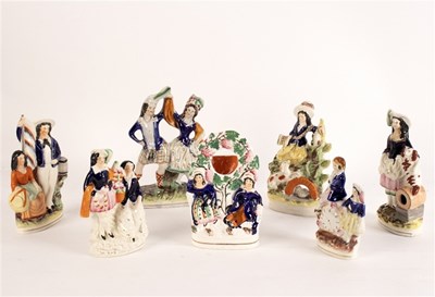 Lot 303 - A Staffordshire flatback group of a lady...