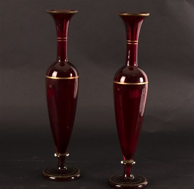 Lot 323 - A pair of red glass vases of baluster form,...