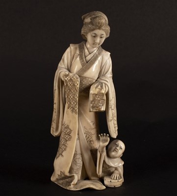 Lot 345 - A Japanese carved ivory figure of a Bijn and...
