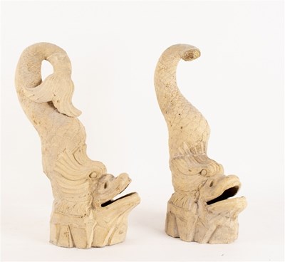Lot 386 - A pair of carved stone dolphins with open...