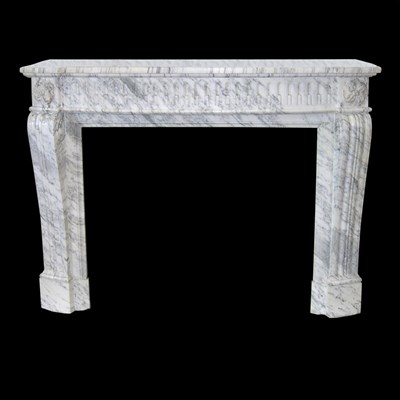 Lot 400 - A carved Louis XVI style chimney piece in...