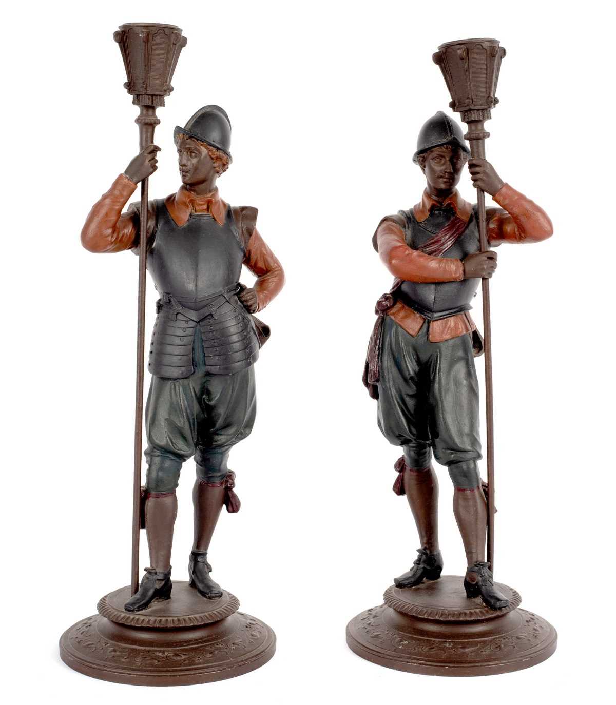 Lot 10 - A pair of figural candlesticks, the supports...