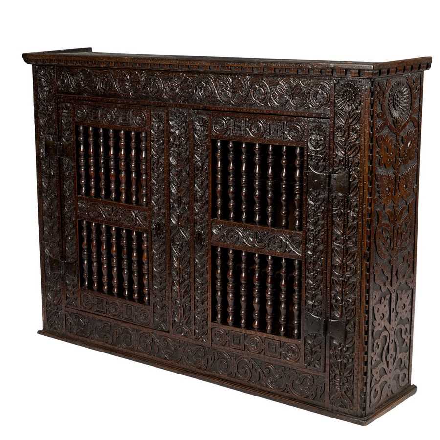 Lot 23 - A 17th Century oak hanging cupboard, with...