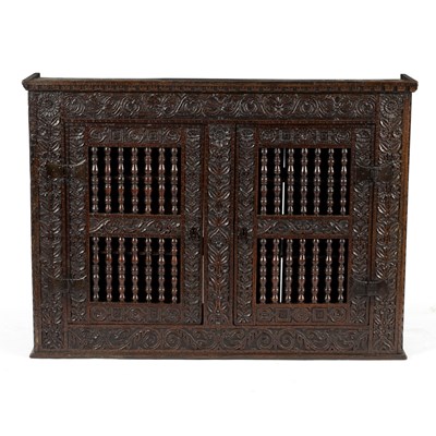 Lot 23 - A 17th Century oak hanging cupboard, with...
