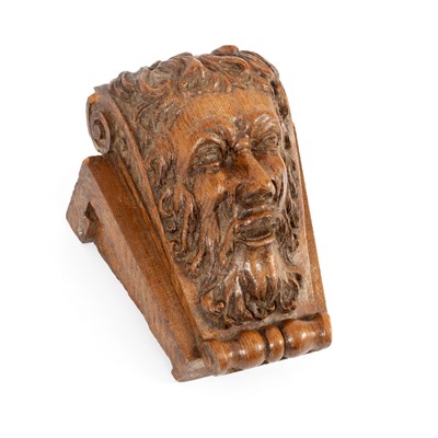 Lot 28 - A mask head carving of a bearded man on a...