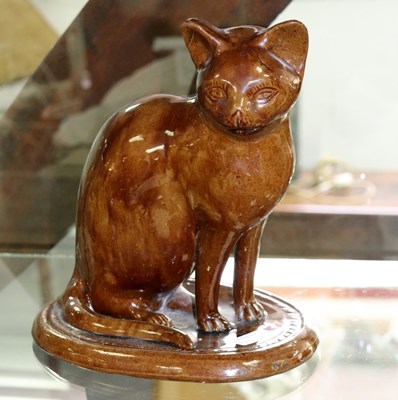 Lot 597 - A mid 19th Century brown glazed pottery cat,...