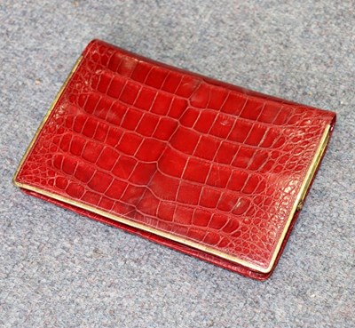 Lot 606 - A red crocodile skin evening bag with gilt...
