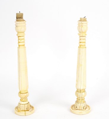 Lot 614 - A pair of Anglo-Indian ivory candlesticks made...