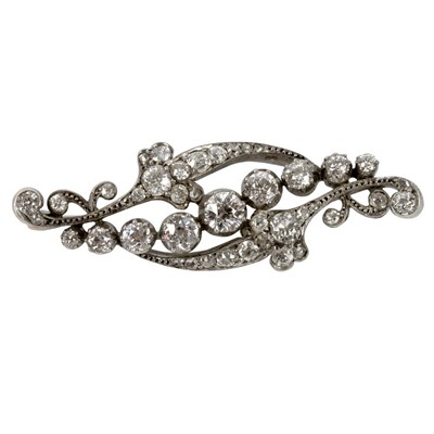 Lot 690 - A diamond brooch of scrolling form, the...