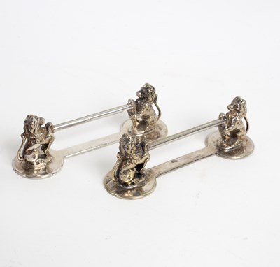 Lot 85 - A pair of plated knife rests with lion...