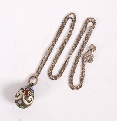 Lot 13 - A Russian silver and enamel egg form pendant...