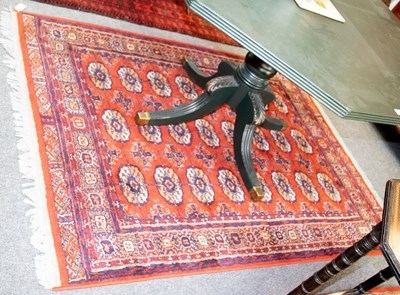 Lot 784 - A Bokhara type rug, three rows of eight guls...