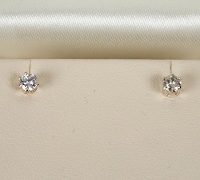 Lot 43 - A pair of diamond ear studs, each stone...