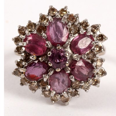 Lot 64 - A ruby and diamond cluster ring, the central...