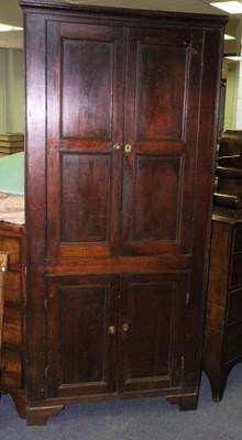 Lot 321 - An early 19th Century oak corner cupboard...