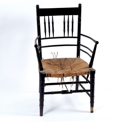 Lot 348 - A Morris & Co. ebonised armchair with rush seat