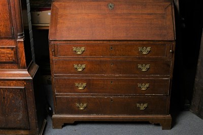 Lot 366 - A George III oak bureau, circa 1900, the...