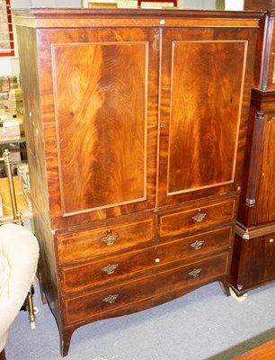 Lot 392 - A George III mahogany linen press, circa 1800,...