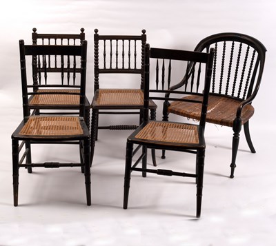 Lot 413 - A pair of ebonised spindle back chairs on...