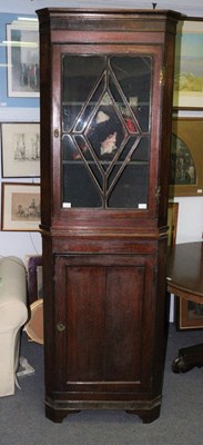 Lot 420 - An early 19th Century oak corner cupboard with...