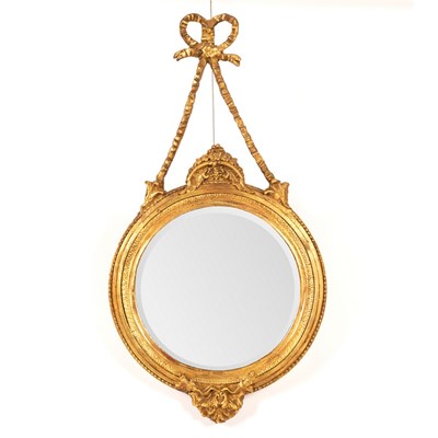 Lot 476 - A circular gilt framed wall mirror suspended...