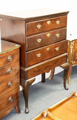 Lot 513 - A Georgian oak chest of three drawers, on a...