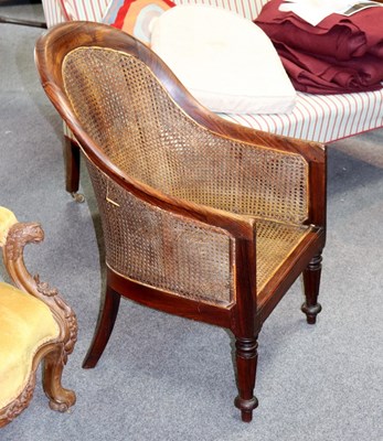 Lot 519 - A Regency rosewood bergère chair on reeded...