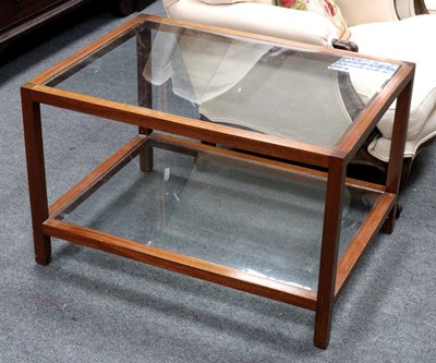 Lot 523 - A modern two-tier table, each tier with glass...