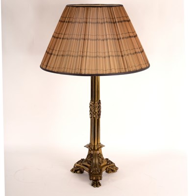 Lot 945 - A gilt brass table lamp of column form, on paw...