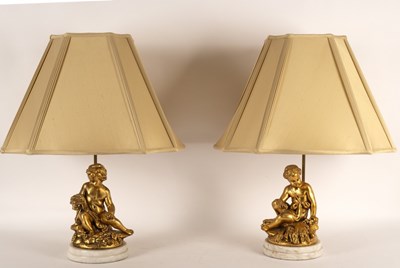 Lot 946 - A pair of table lamps with gilt putto bases,...