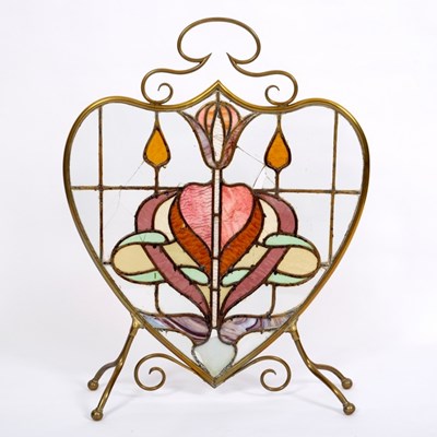 Lot 297 - An Art Nouveau style fire screen, the brass...