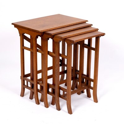 Lot 328 - An Arts & Crafts style nest of four oak tables...
