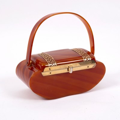Lot 668 - A 1940s bakelite handbag, casket shaped with...