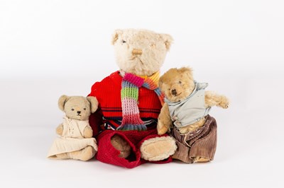 Lot 392 - A teddy bear wearing a knitted scarf, jumper...