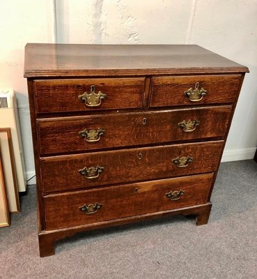 Lot 511 - A George III oak chest of two short and three...