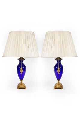 Lot 838 - A pair of blue glass vase-shaped table lights,...