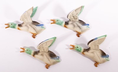 Lot 154 - Poole Pottery, a set of four flying duck wall...
