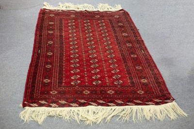 Lot 782 - A Turkoman rug, the red field with three rows...