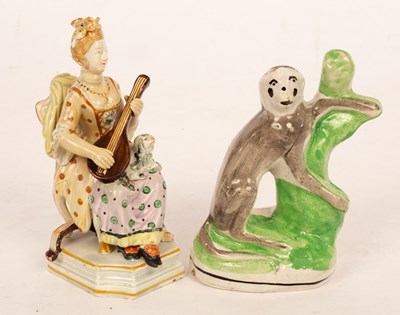 Lot 59 - A Staffordshire flatback figure of a grey...