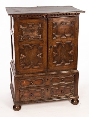 Lot 589 - An 18th Century oak cupboard, the two panelled...