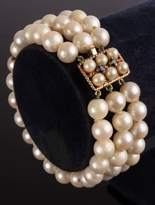 Lot 190 - A three row cultured pearl bracelet,...