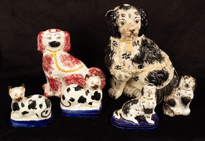 Lot 285 - Four Staffordshire figures of seated spaniels...