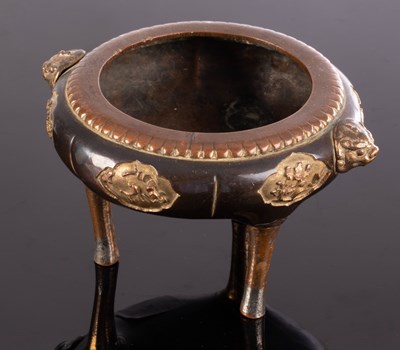 Lot 386 - A Japanese bronze incense burner with gilded...