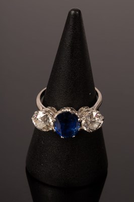 Lot 6 - A sapphire and diamond three-stone ring, the...