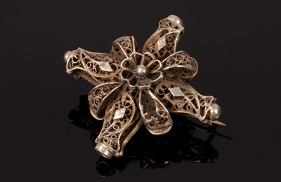 Lot 39 - An Eastern white metal brooch of cross form,...