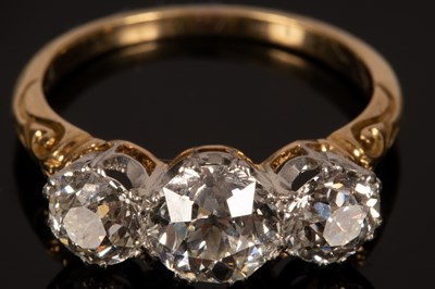 Lot 4 - A diamond three-stone ring, the central stone...