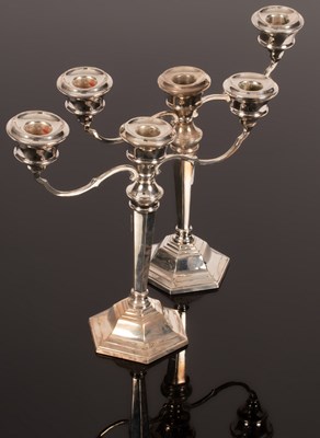 Lot 124 - A pair of modern silver two-branch, three...