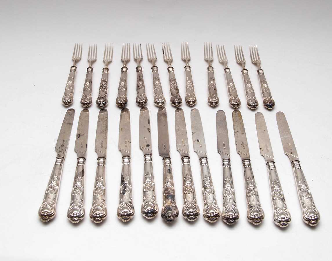 Lot 11 - A set of twelve silver desert knives and forks,...