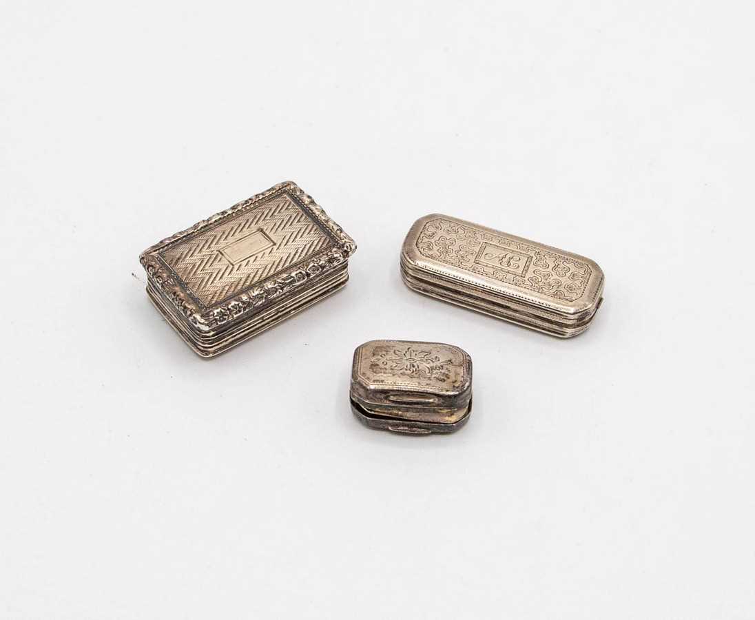 Lot 46 - Three Georgian silver vinaigrettes, the...